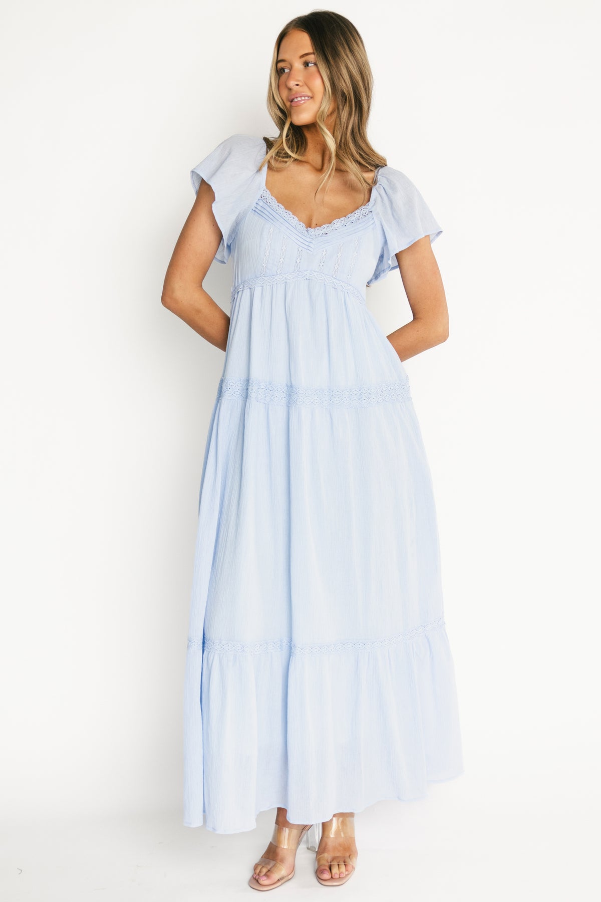 Studio image of the tiered maxi skirt in motion, showing volume, lace trim accents, and textured 100% cotton fabric.