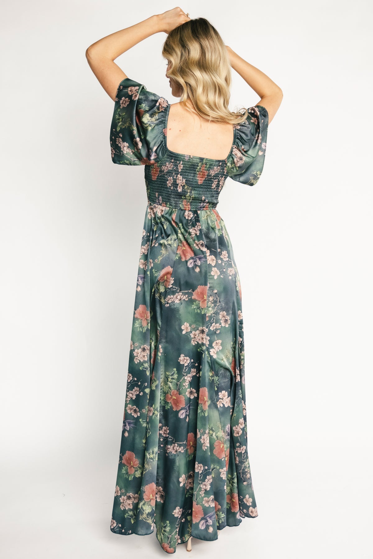 Back view highlighting the smocked stretch back and empire waist for a flexible, flattering fit in the maxi dress.