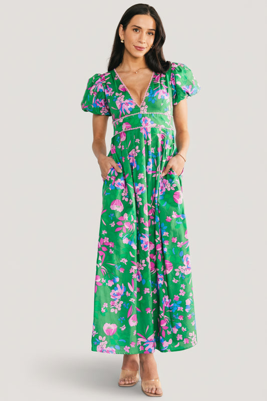 Front full-length view of the Anya Maxi Dress in green multi floral print showing lace-trim V-neck and short puffed sleeves.