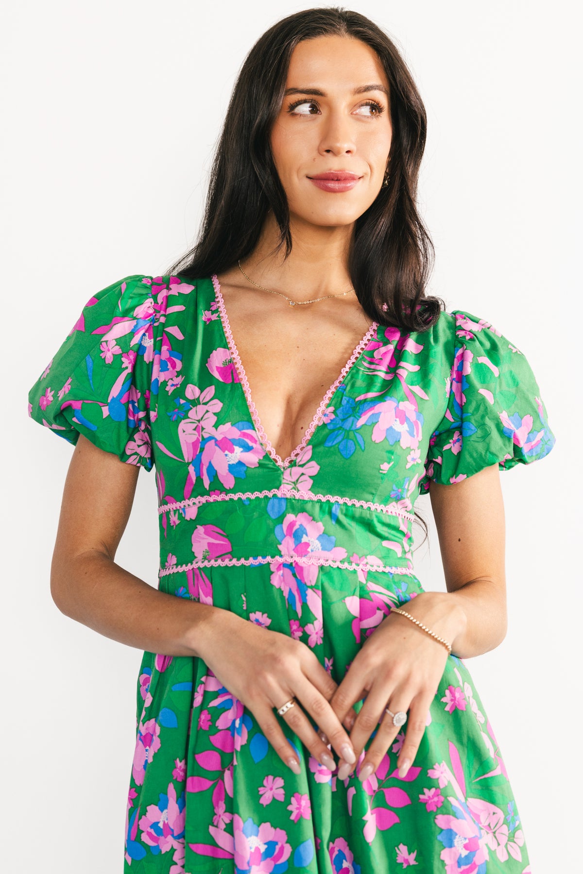 Three-quarter angle of the Anya Maxi Dress highlighting the tailored front panel, vibrant pink-blue florals, and smooth lined skirt.