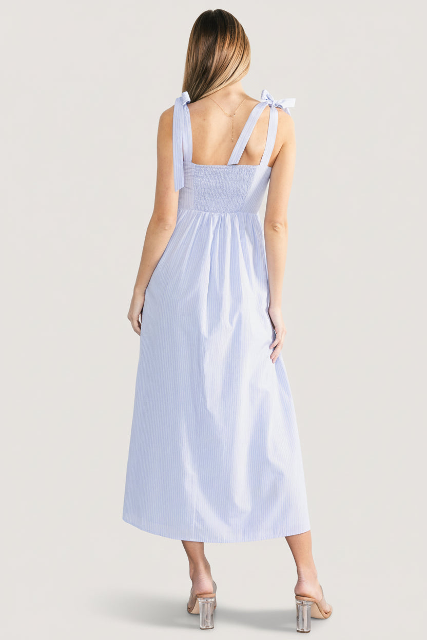 Back view of Enora maxi dress showing smocked back panel and adjustable self-tie shoulder straps for fit.