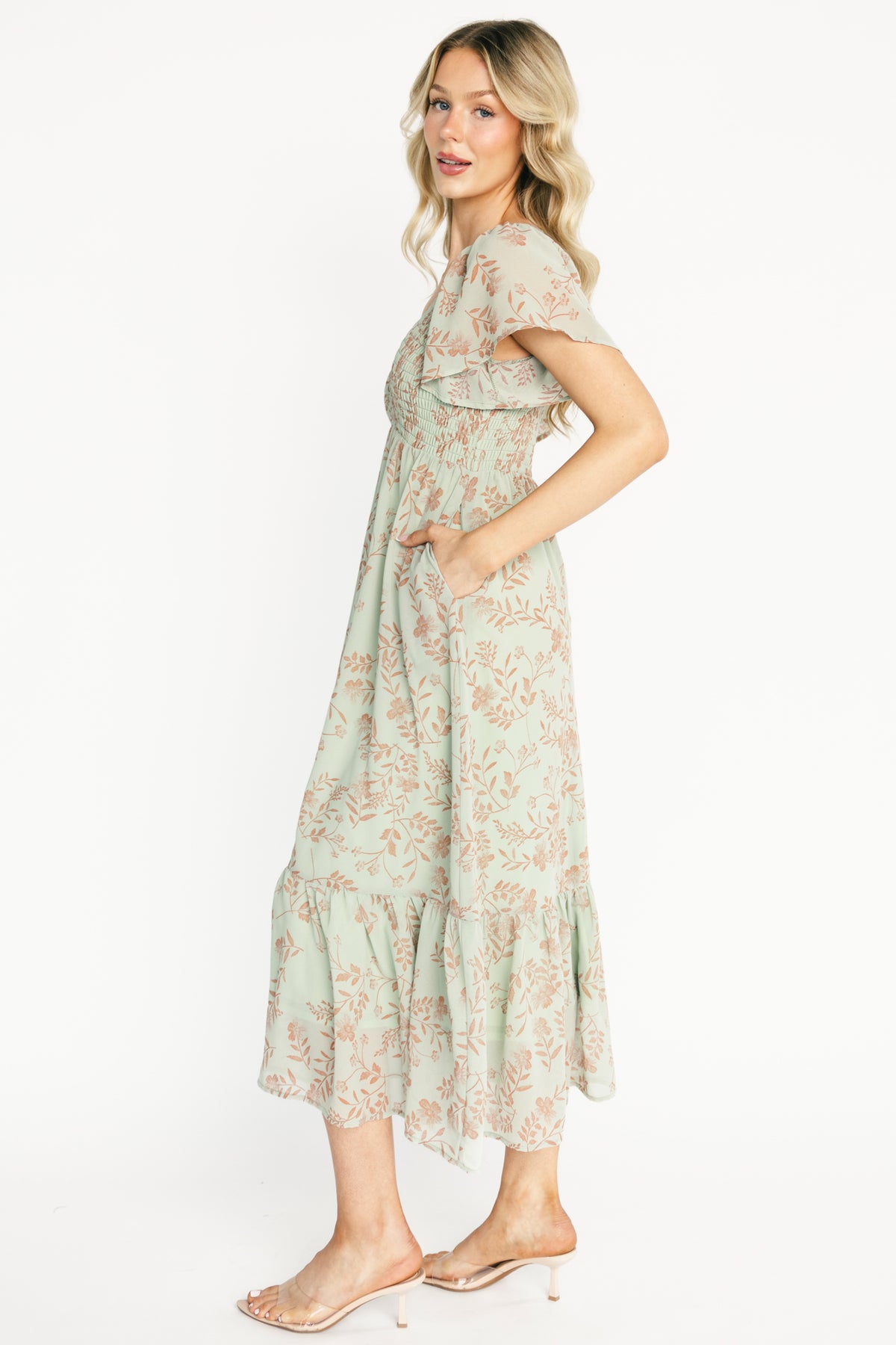 Detail shot of the lightweight chiffon overlay and the fully lined skirt, highlighting fabric texture and terracotta floral print on dusty sage.