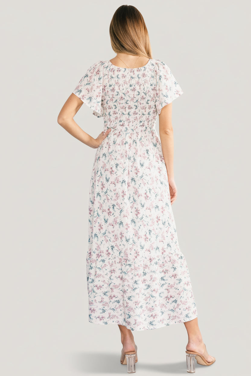 Back view of Joanie smocked midi dress showing full lining through the bodice, gentle gathering at the waist, and single-tier flowy skirt.