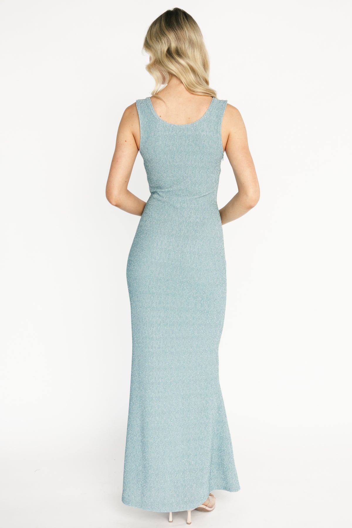 Styled full-length shot of the dusty light blue Desi Shimmer maxi gown on model, showing flow, length, and subtle sparkle.