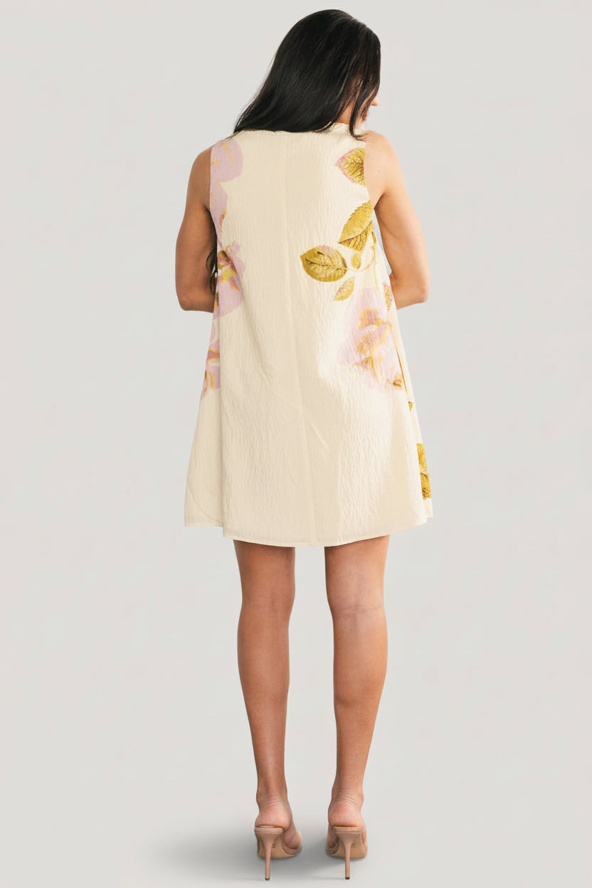 Three-quarter angle view showing the dress's sleeveless shift silhouette, V-neckline, and airy crinkled texture.