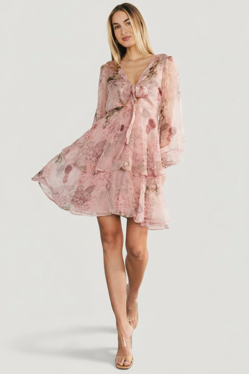Front view of Zoemy short dress in dusty rose floral, V-neck with keyhole ties, sheer long sleeves and tiered mini skirt.