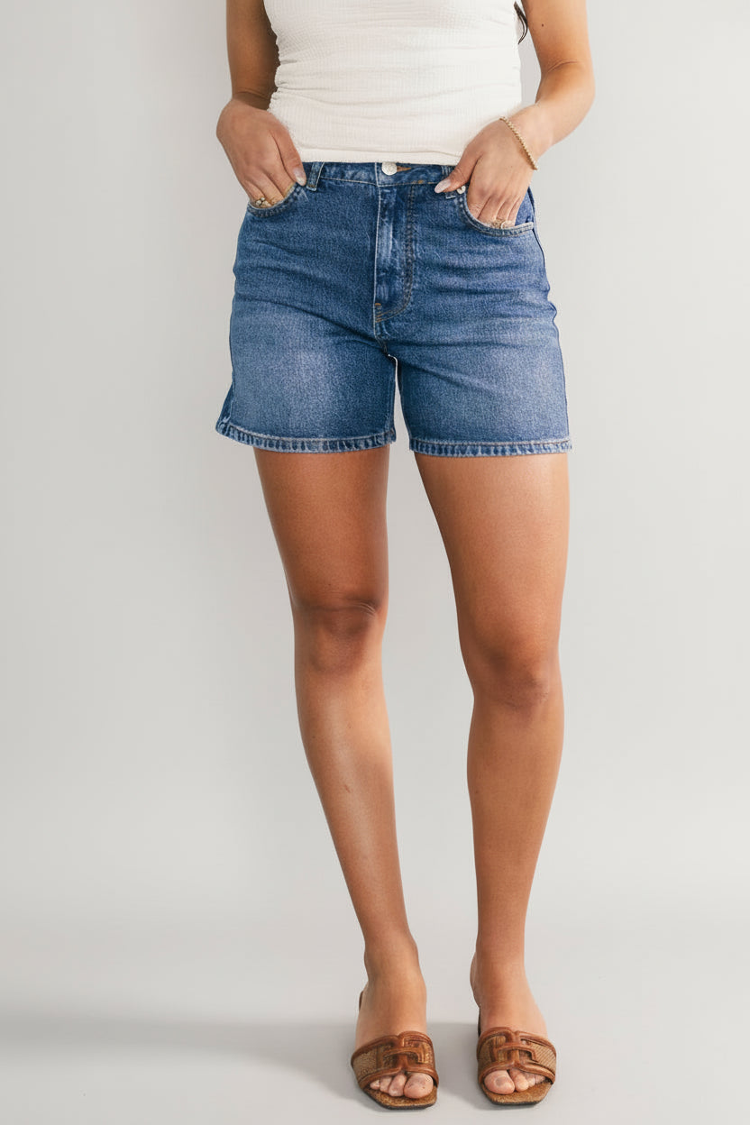 Front view of Lennon High-Rise Jean Shorts in medium-wash denim, showing frayed hem, high-rise waist, and front pockets.