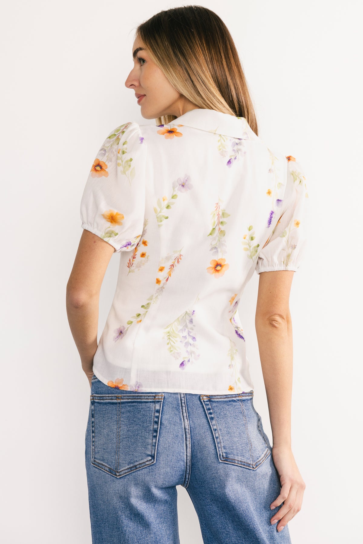 Back view of the Fiona Button-Up Blouse showing full-length back, floral pattern continuity, and how the lined polyester fabric sits smoothly across shoulders and upper back.