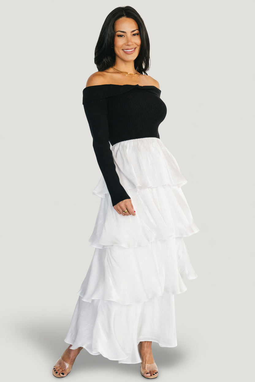 Back view of Maelie dress showing seam lines, skirt tiers, and the contrast between the black sweater top and white satin skirt.