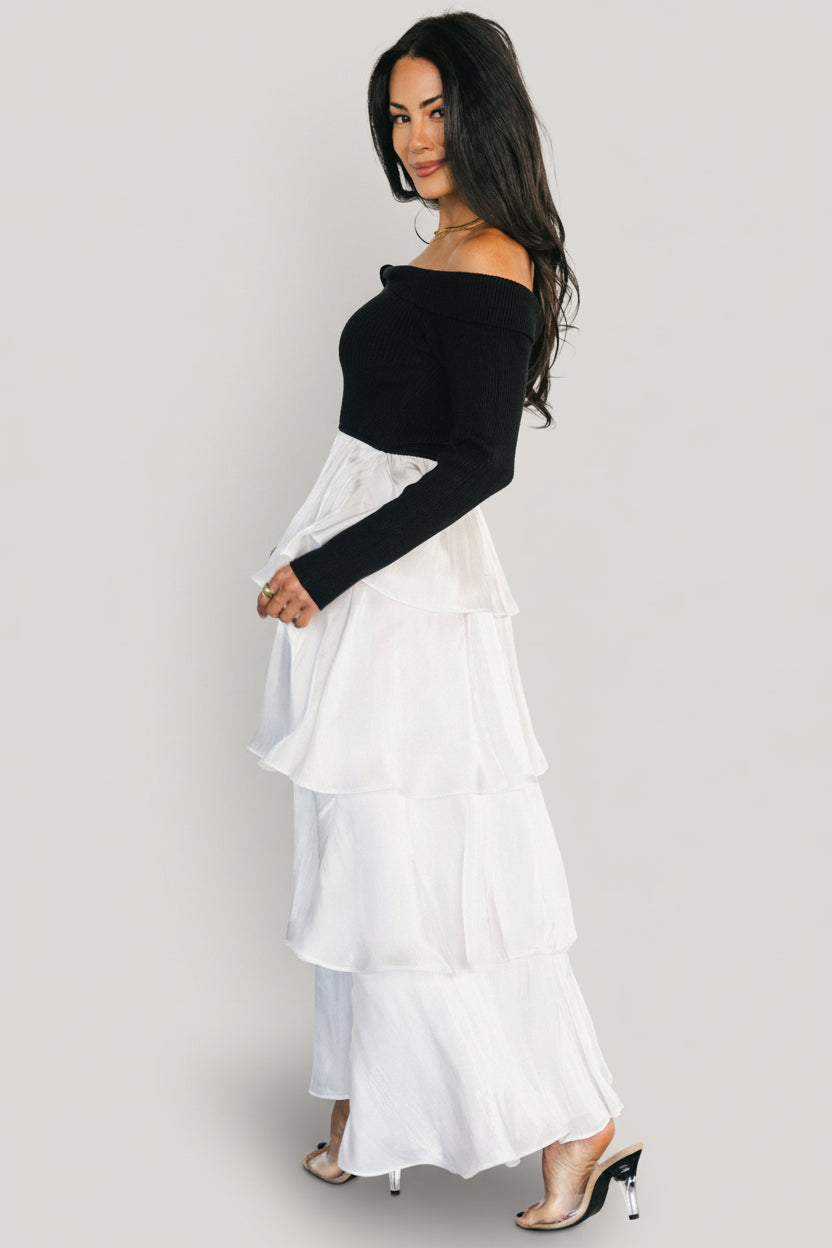 Close-up of bodice texture and ribbed sweater fabric highlighting the fitted stretch top and twist neckline detail.