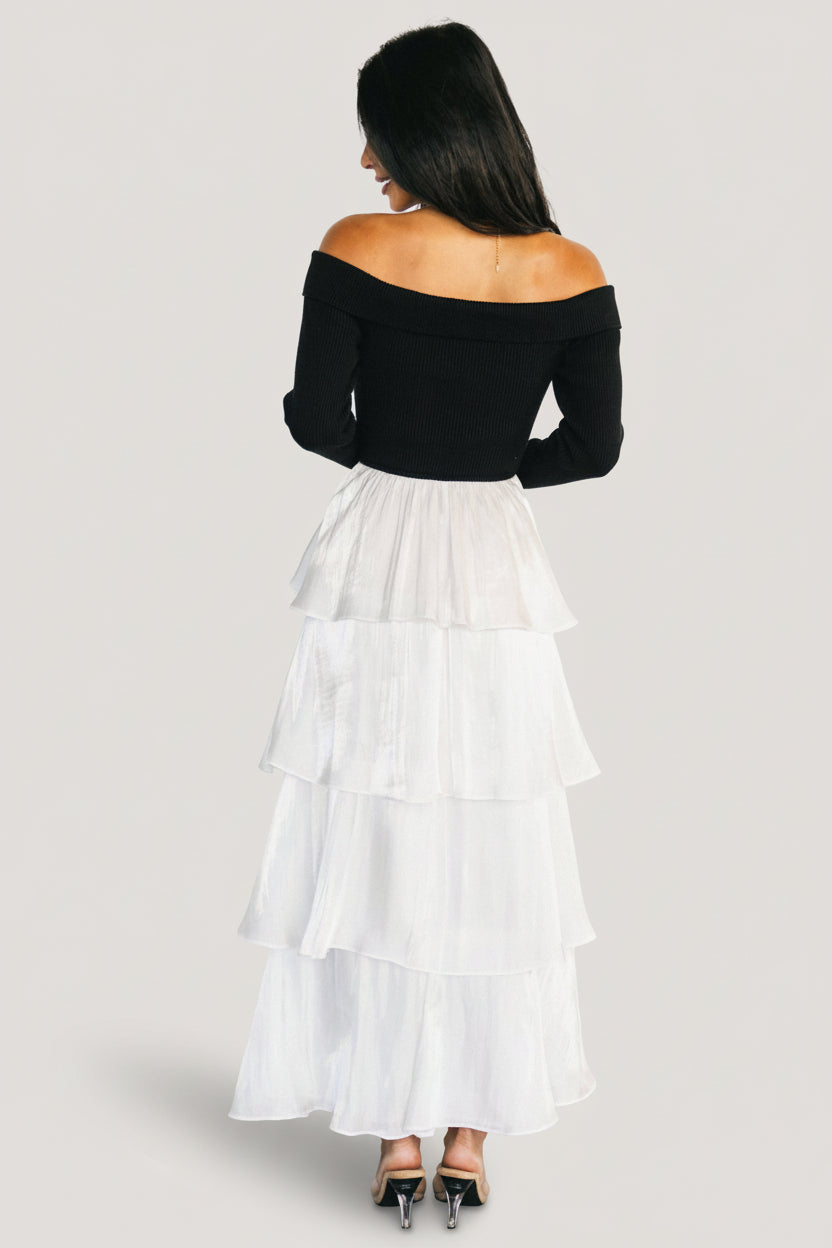 Side view of dress showing A-line silhouette and layered ruffle tiers of the white satin skirt with lined interior.