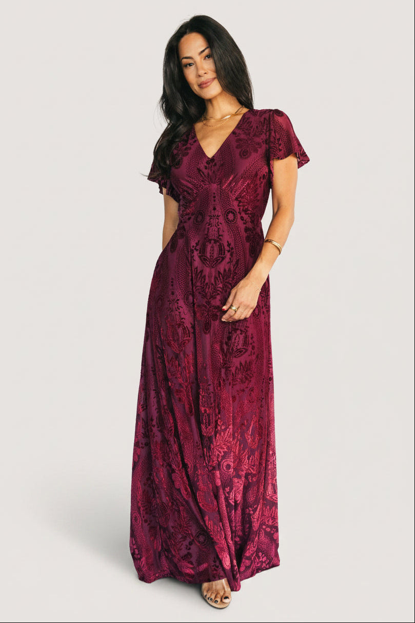 Front view of Kimberly Velvet Maxi Dress in wine with V-neck, empire waist, burnout floral velvet overlay, and flowing full-length skirt.