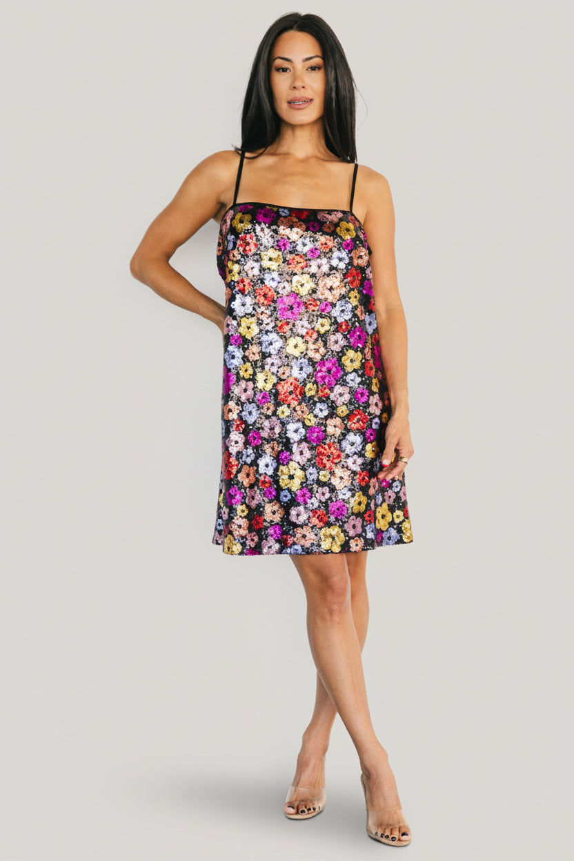 Model wearing the Malia Sequin Mini Dress styled with minimal accessories, highlighting the dress's sparkle and relaxed boxy fit.