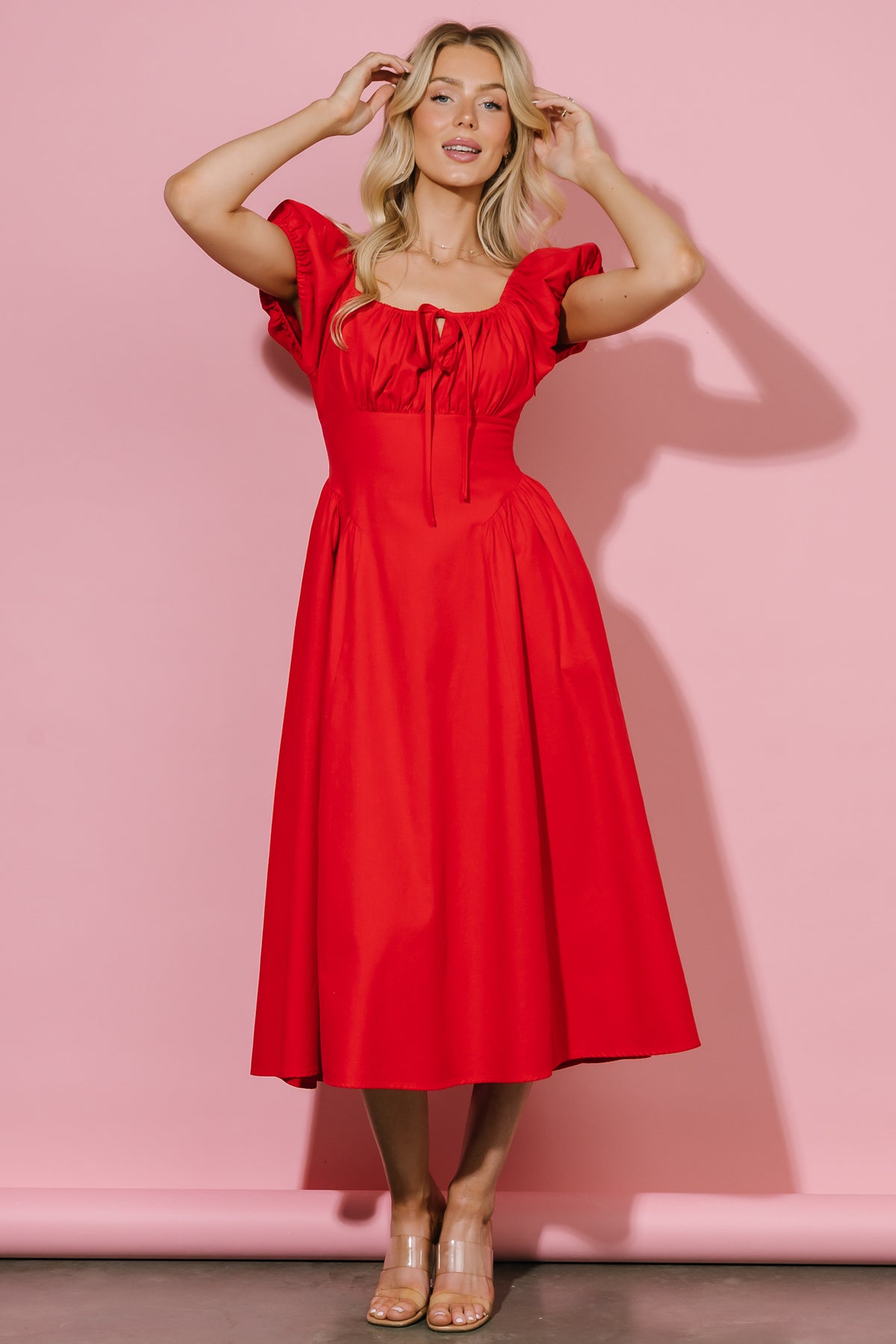 Close-up detail of the dress fabric and pleating at the hips, showing stitch detail and medium-weight cotton texture.