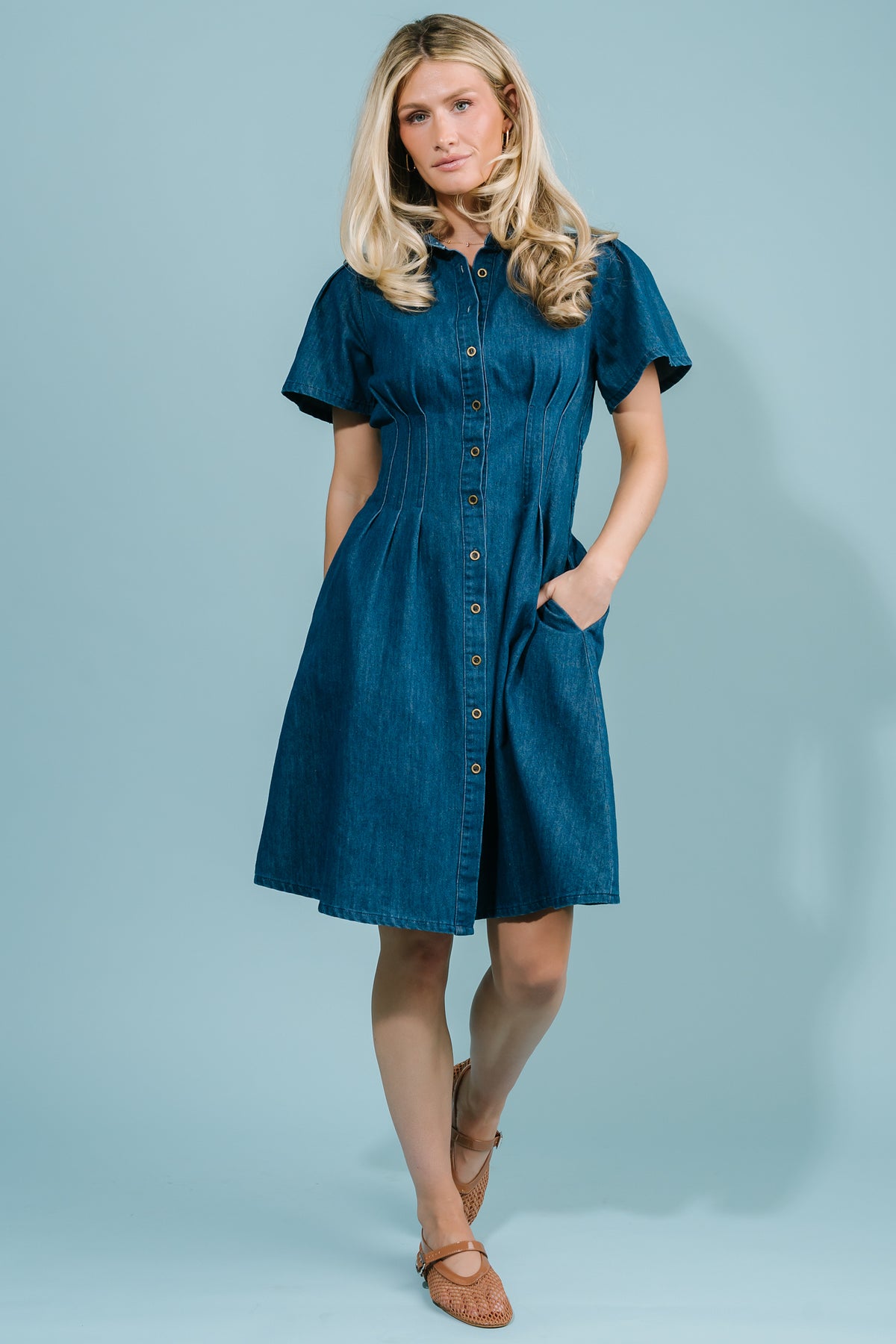 Close-up of button-down front, collared neckline, and mid-weight cotton denim texture on the Coco Denim Short Dress in dark blue wash.