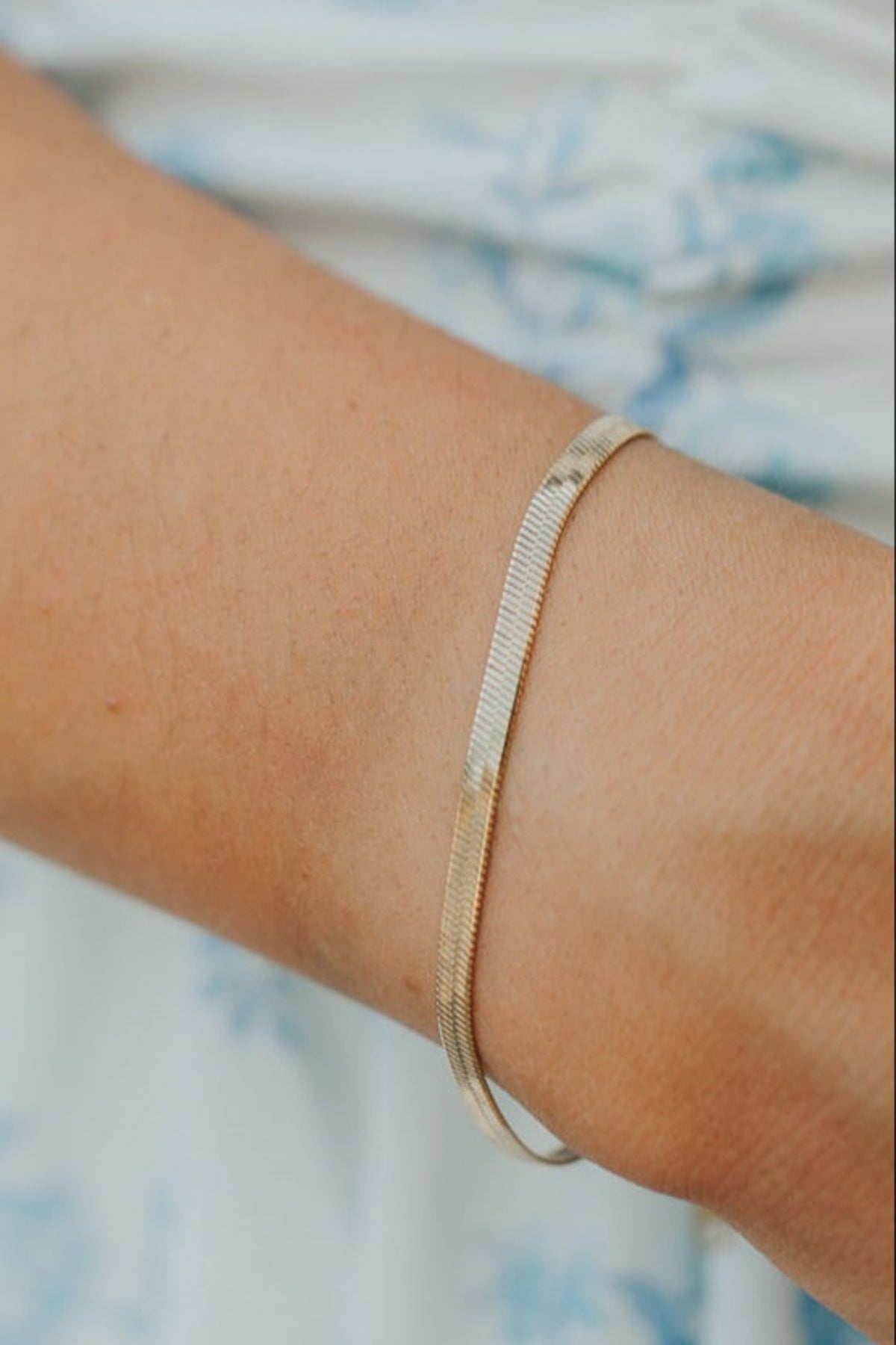 Product shot of the Christina bracelet laid flat to display the extender clasp and approximate 7 inch length with detailed link texture.
