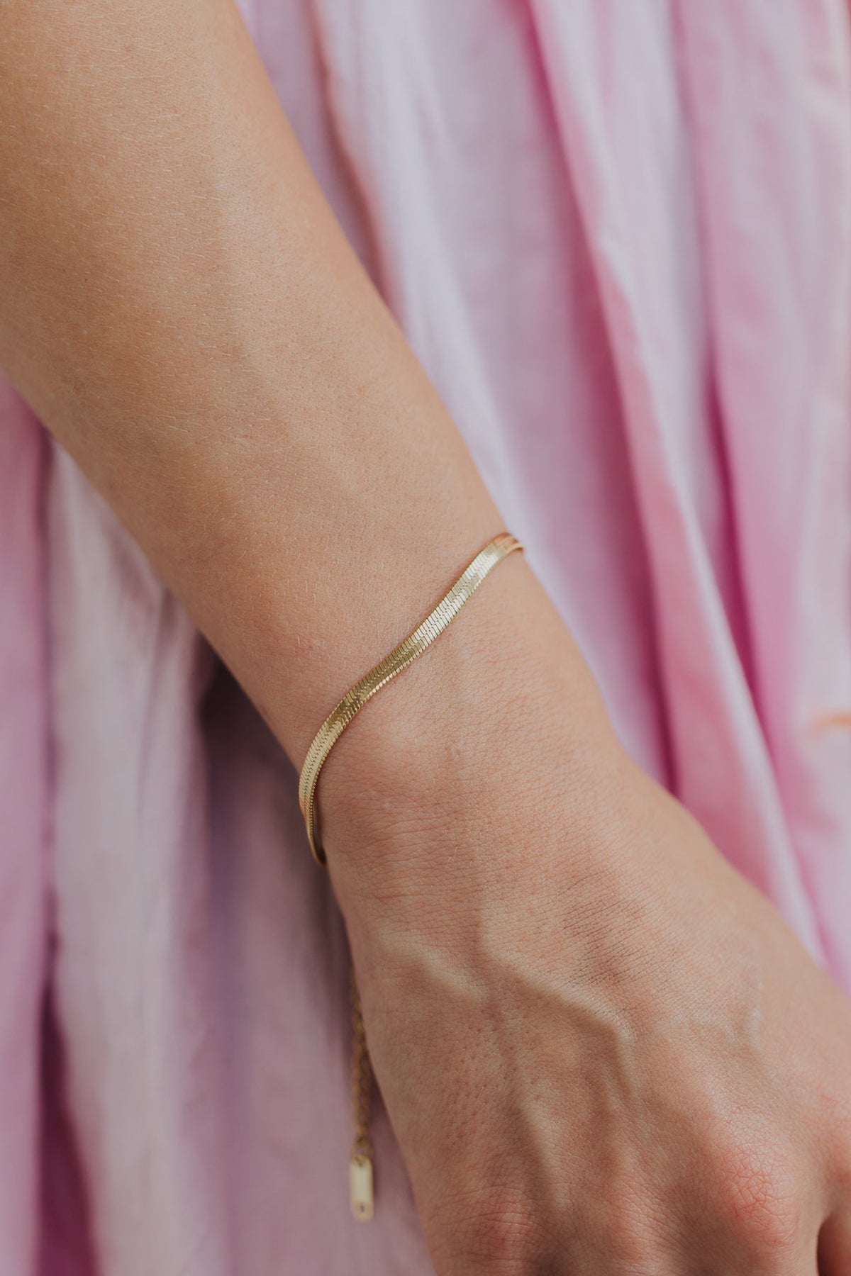 The Christina bracelet paired with other bangles to demonstrate stacking options and how the flat design layers with mixed textures.
