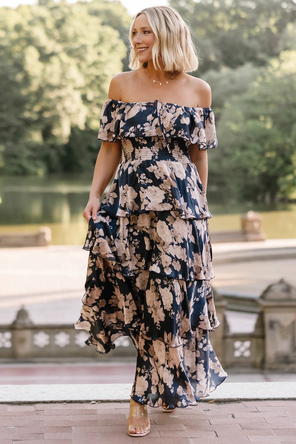Isabelle Off Shoulder Maxi Dress in Multi Floral with elastic neckline, ruffle bust, smocked waist, and four-tiered skirt.