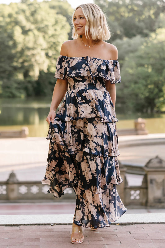 Isabelle Off Shoulder Maxi Dress in Multi Floral with elastic neckline, ruffle bust, smocked waist, and four-tiered skirt.
