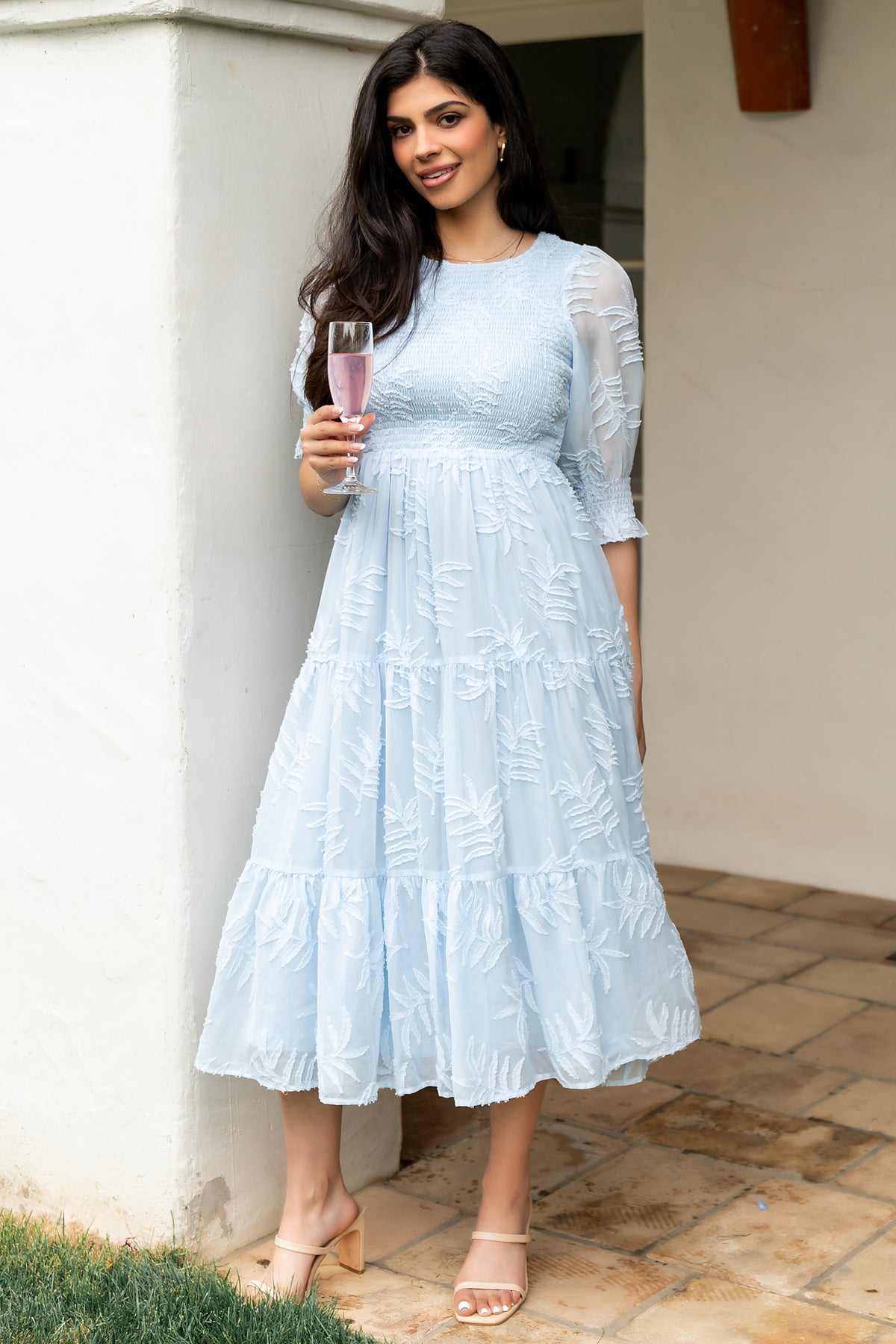 Close-up of the smocked bodice and round neckline on the Nellie Smocked Midi Dress, showing texture and burnout floral detailing on chiffon.