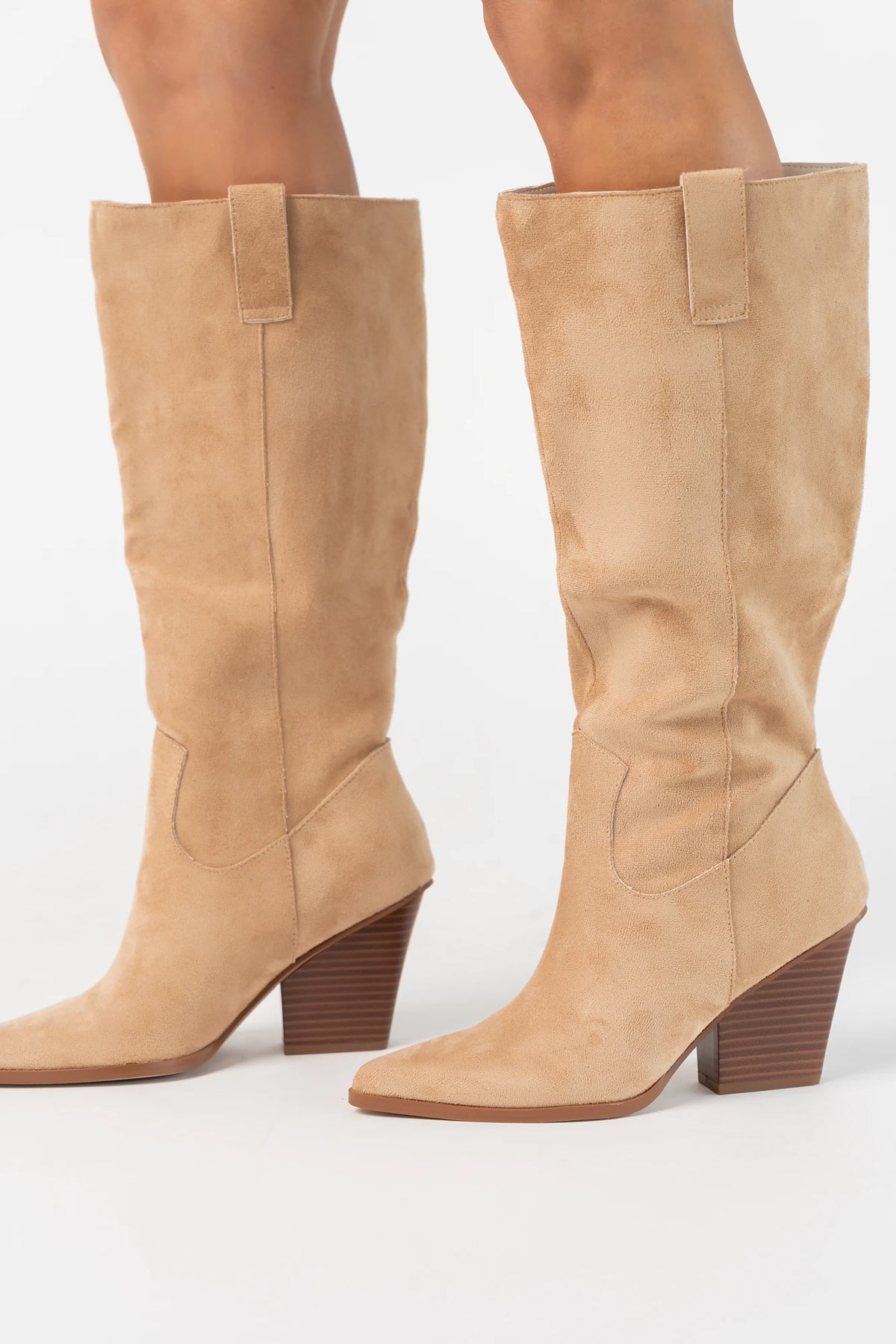 Wren Tall Western Boot in Beige with faux suede finish, pointed toe, angled stacked heel, and pull tab.