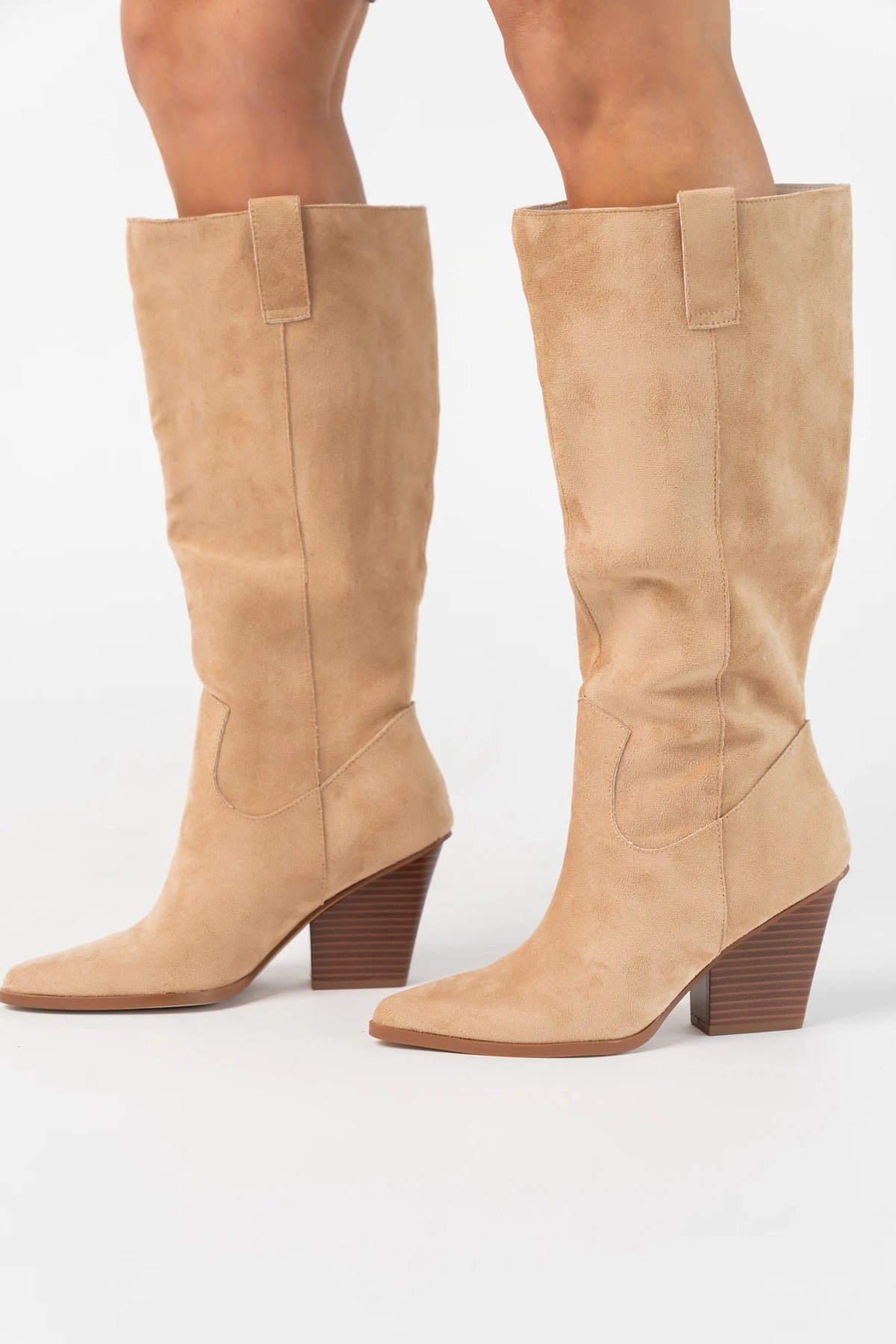 Wren Tall Western Boot in Beige with faux suede finish, pointed toe, angled stacked heel, and pull tab.