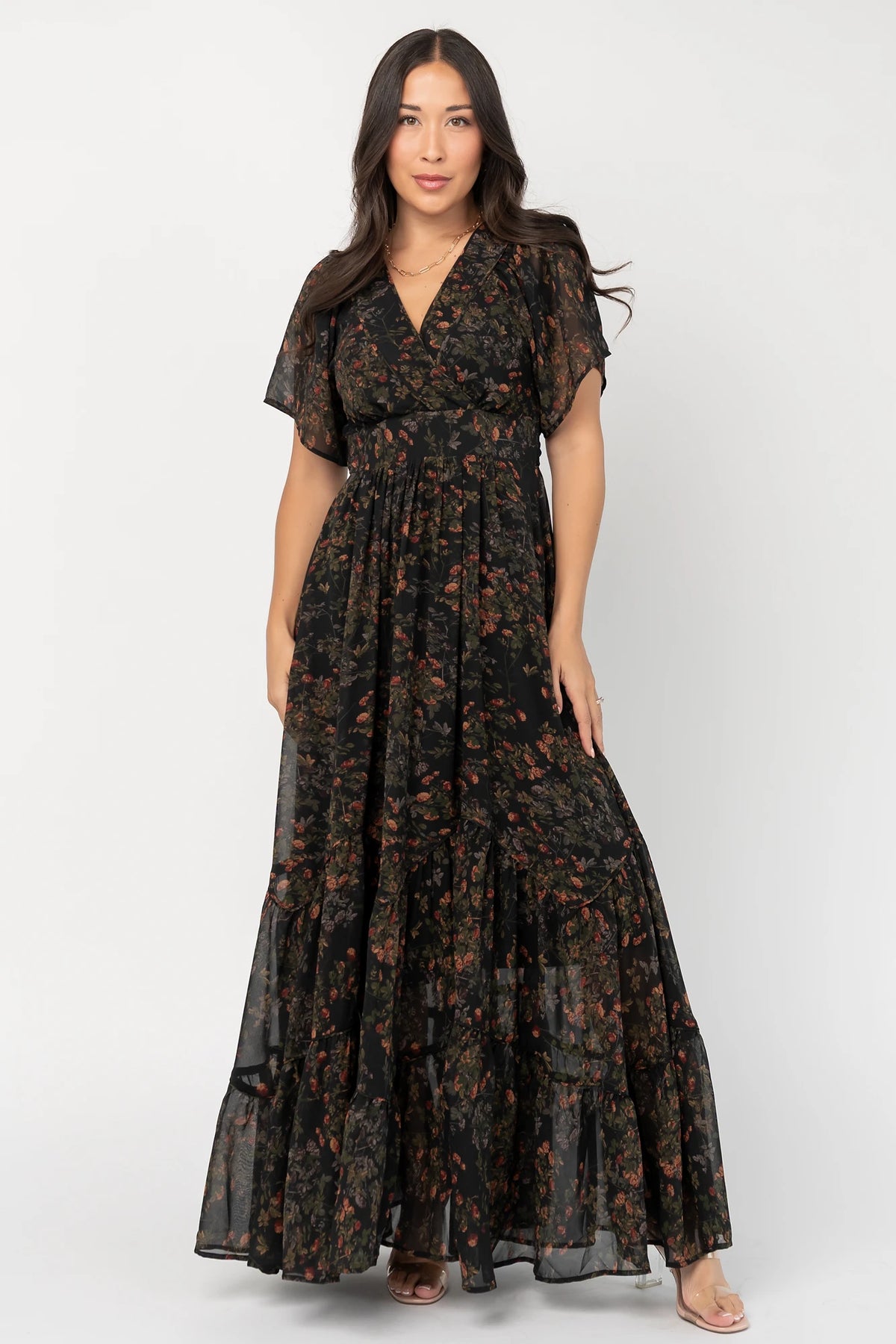 Katherine Maxi Dress in Black Multi Print with surplice V-neck, flutter sleeves, adjustable waist ties, and tiered skirt.