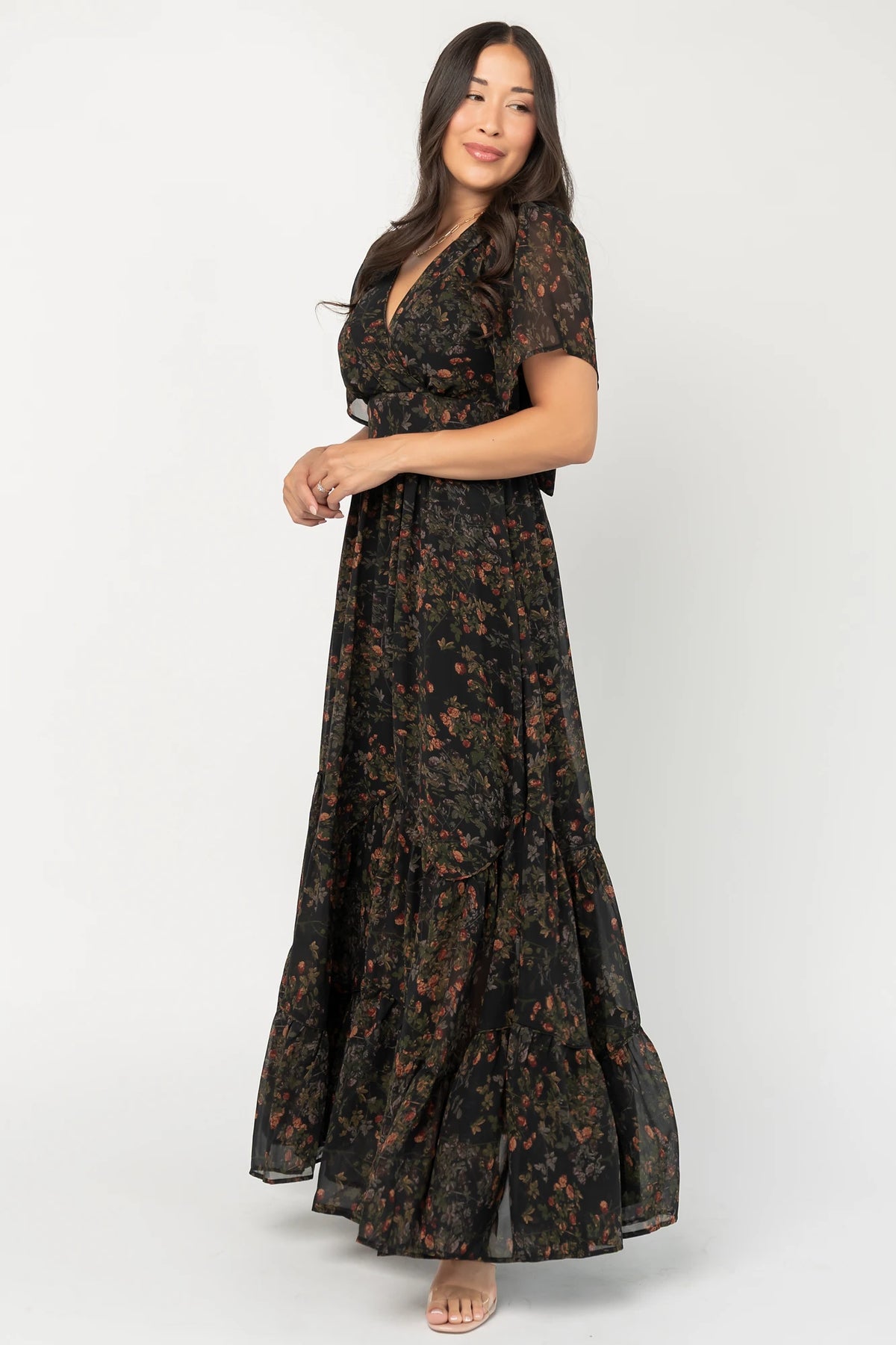 Katherine Maxi Dress in Black Multi Print with surplice V-neck, flutter sleeves, adjustable waist ties, and tiered skirt.