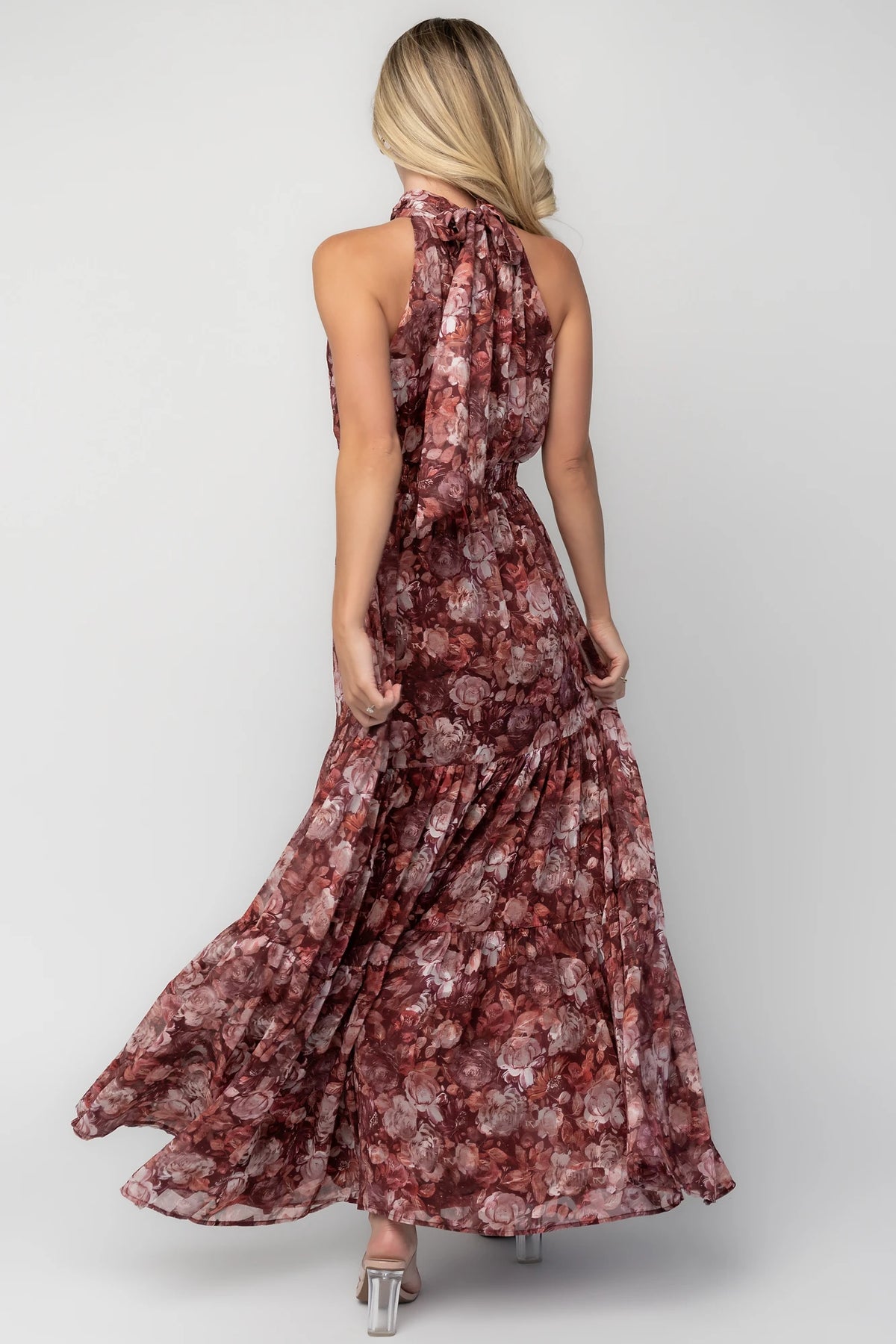 Model wearing the Pulitzer Maxi Dress in Burgundy Floral featuring a rich burgundy floral print on lightweight burnout chiffon. 