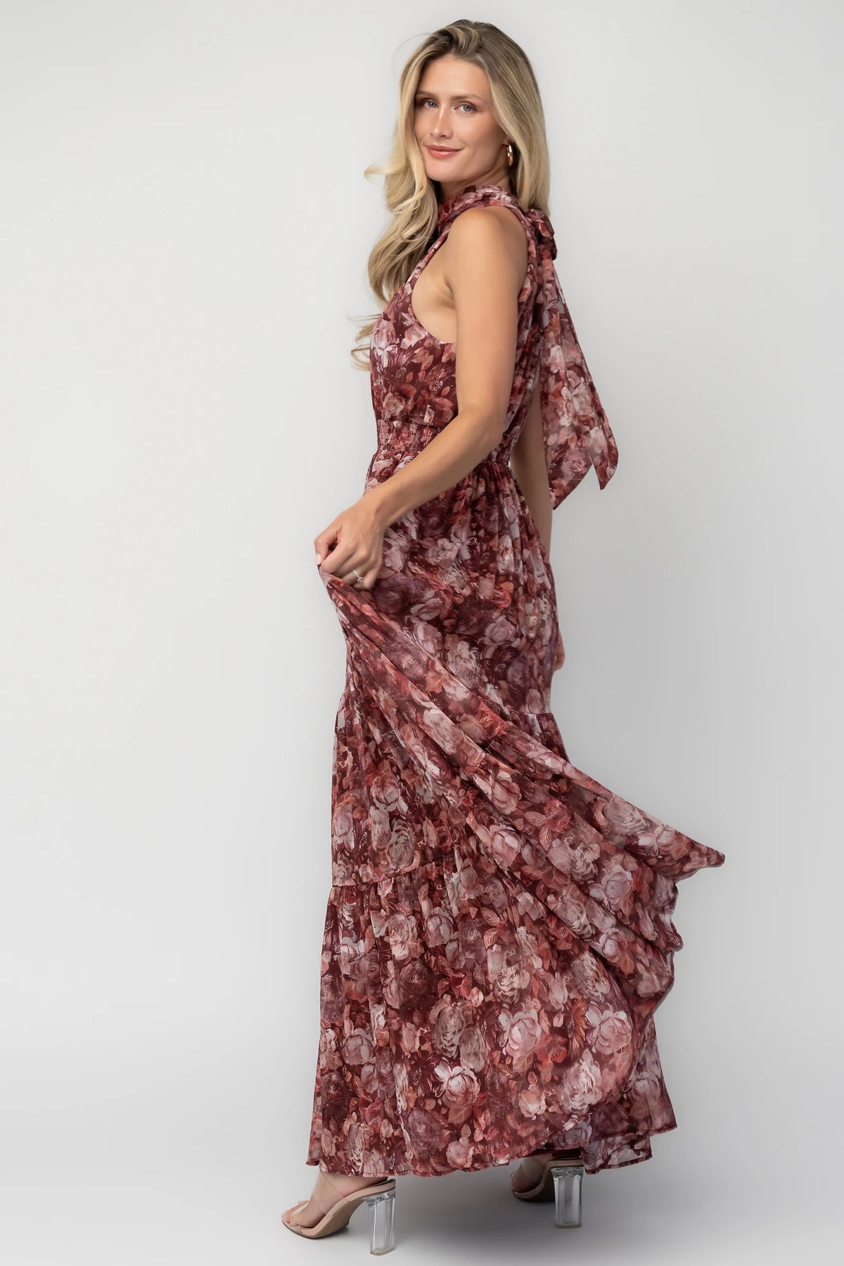 Model wearing the Pulitzer Maxi Dress in Burgundy Floral featuring a rich burgundy floral print on lightweight burnout chiffon. 