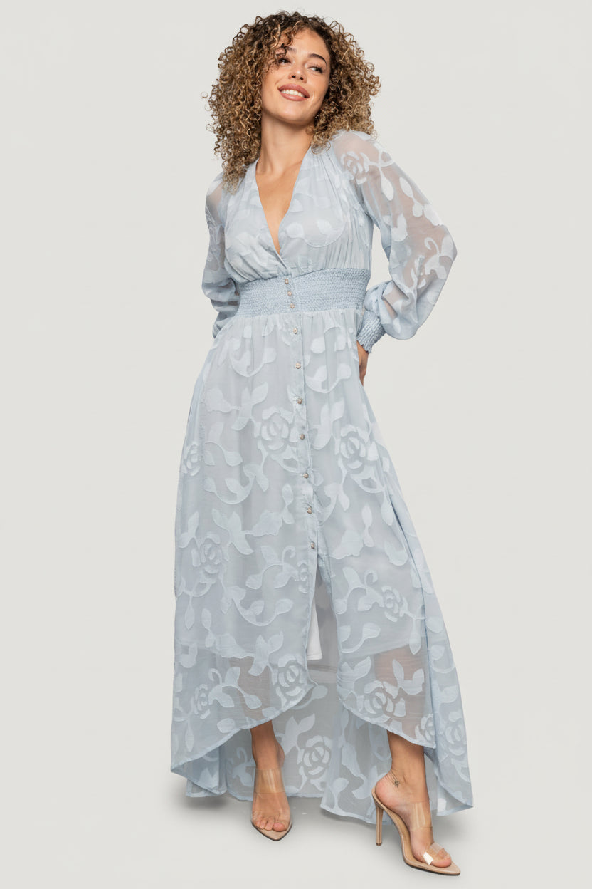 Back and side view of the Daniella dress highlighting the smocked waistband and movement of the high-low hem in burnout floral chiffon.
