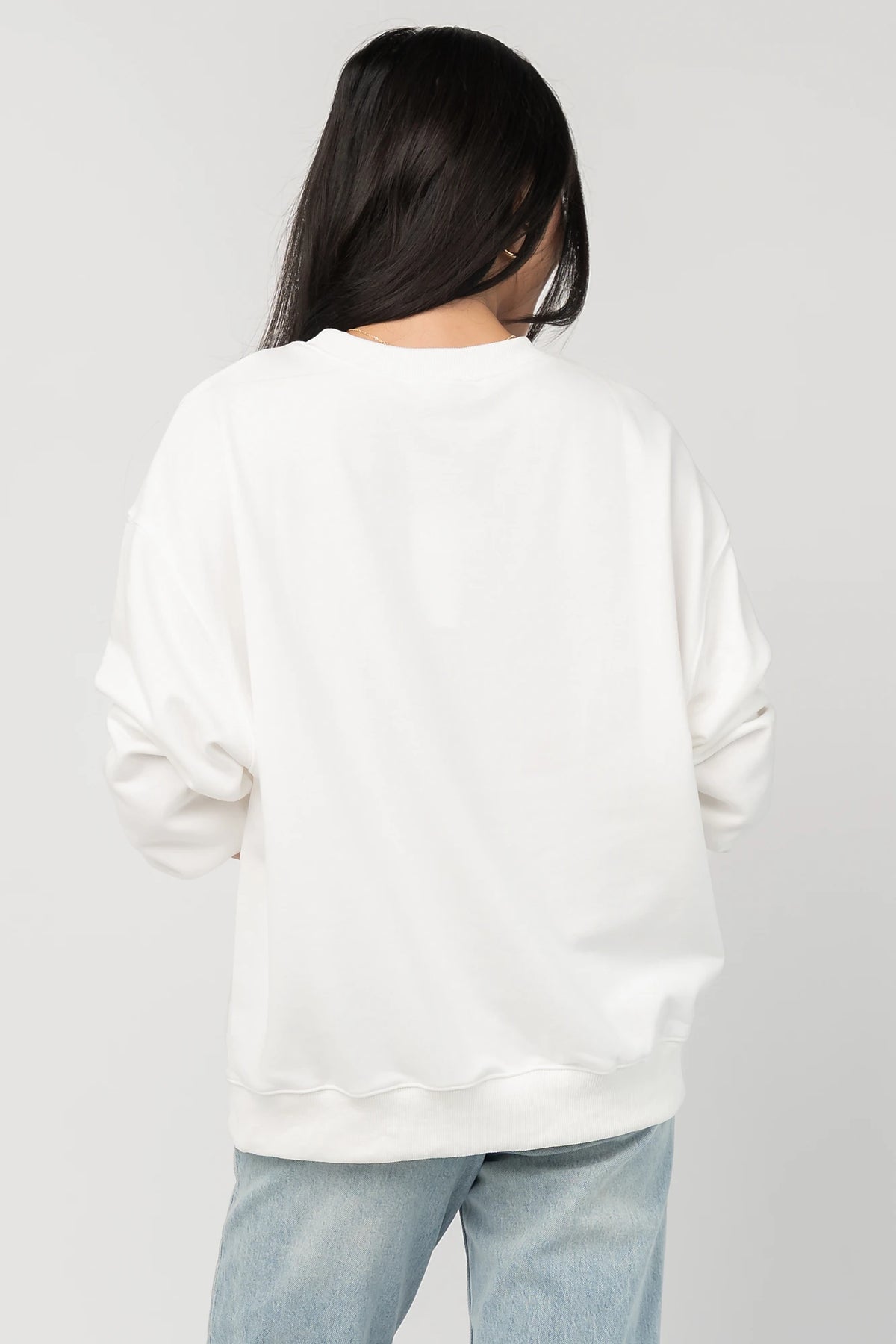 Stephen Gingham Crewneck in Ivory with brown gingham lace appliqué, ribbon bow detail, long sleeves, and ribbed trim.