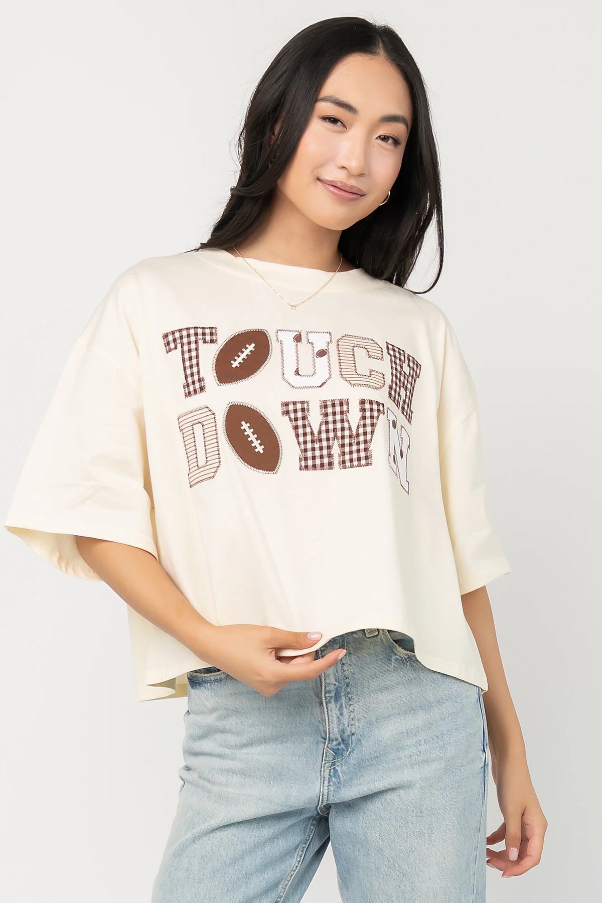 Jason Graphic Tee in Cream with vintage football graphic, gingham, lace and bow appliqué, crew neckline, and short sleeves.