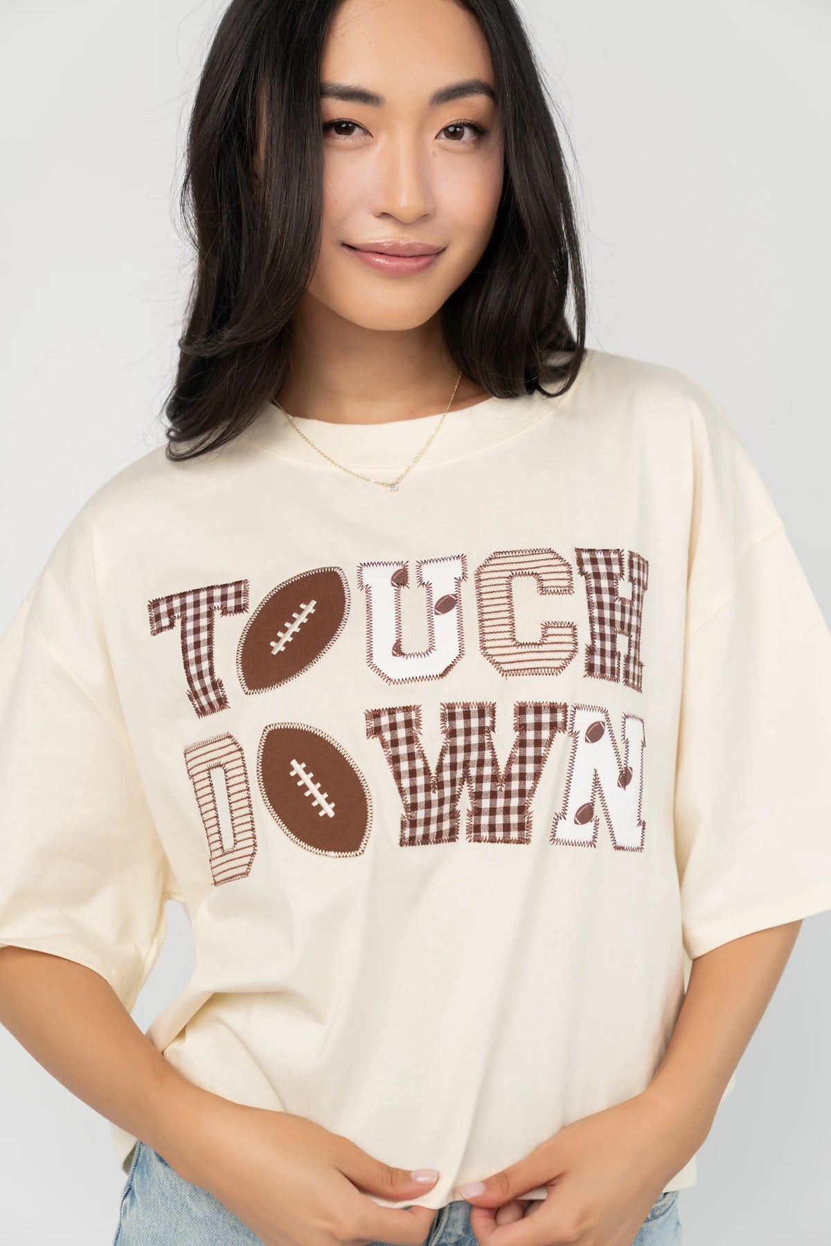 Jason Graphic Tee in Cream with vintage football graphic, gingham, lace and bow appliqué, crew neckline, and short sleeves.