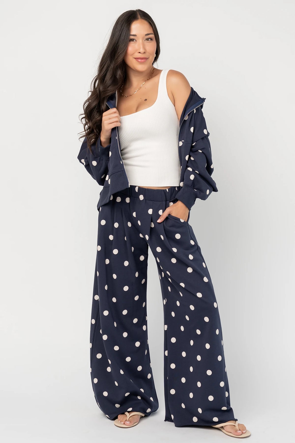 Lydia Zip Up Hoodie in Navy Dot with polka dot print, oversized fit, adjustable hood, zip front, and kangaroo pockets.