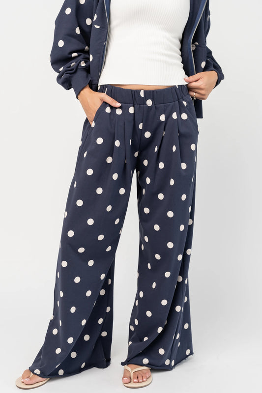 Lydia Wide Leg Sweatpants in Navy Dot with polka dot print, elastic waistband, side pockets, and raw hem.