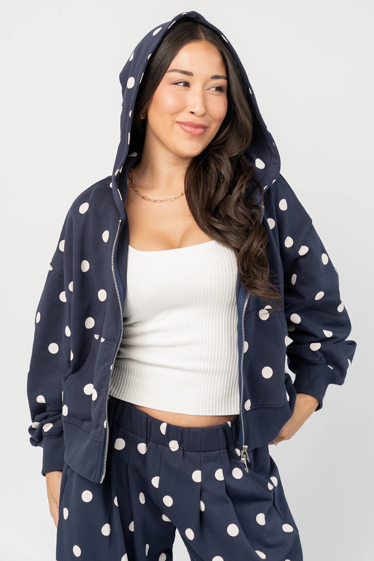 Lydia Zip Up Hoodie in Navy Dot with polka dot print, oversized fit, adjustable hood, zip front, and kangaroo pockets.