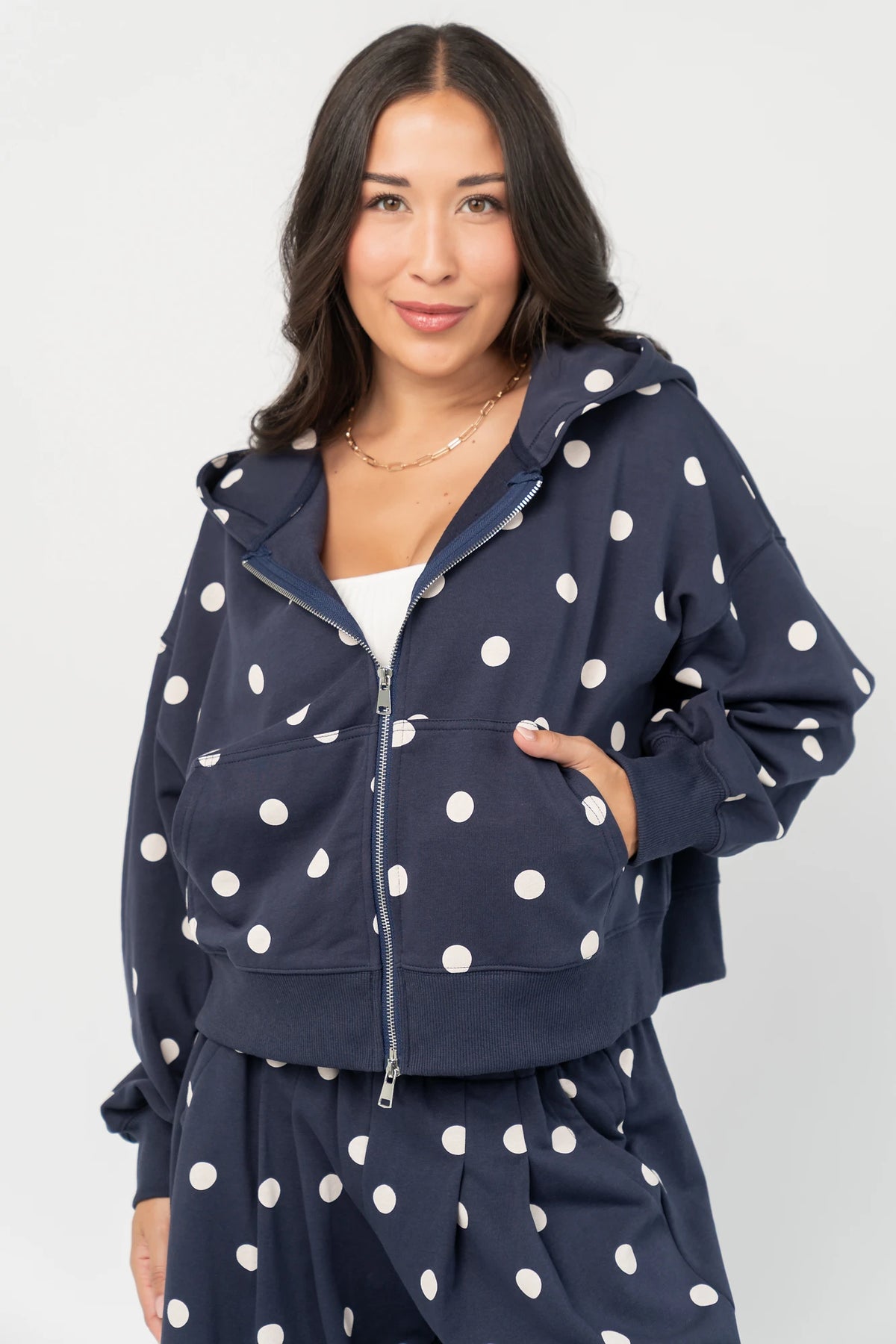 Lydia Zip Up Hoodie in Navy Dot with polka dot print, oversized fit, adjustable hood, zip front, and kangaroo pockets.