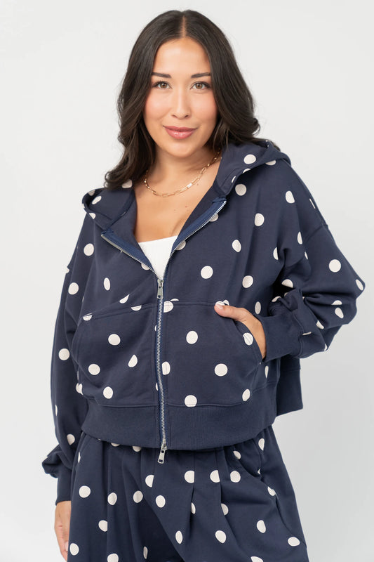 Lydia Zip Up Hoodie in Navy Dot with polka dot print, oversized fit, adjustable hood, zip front, and kangaroo pockets.