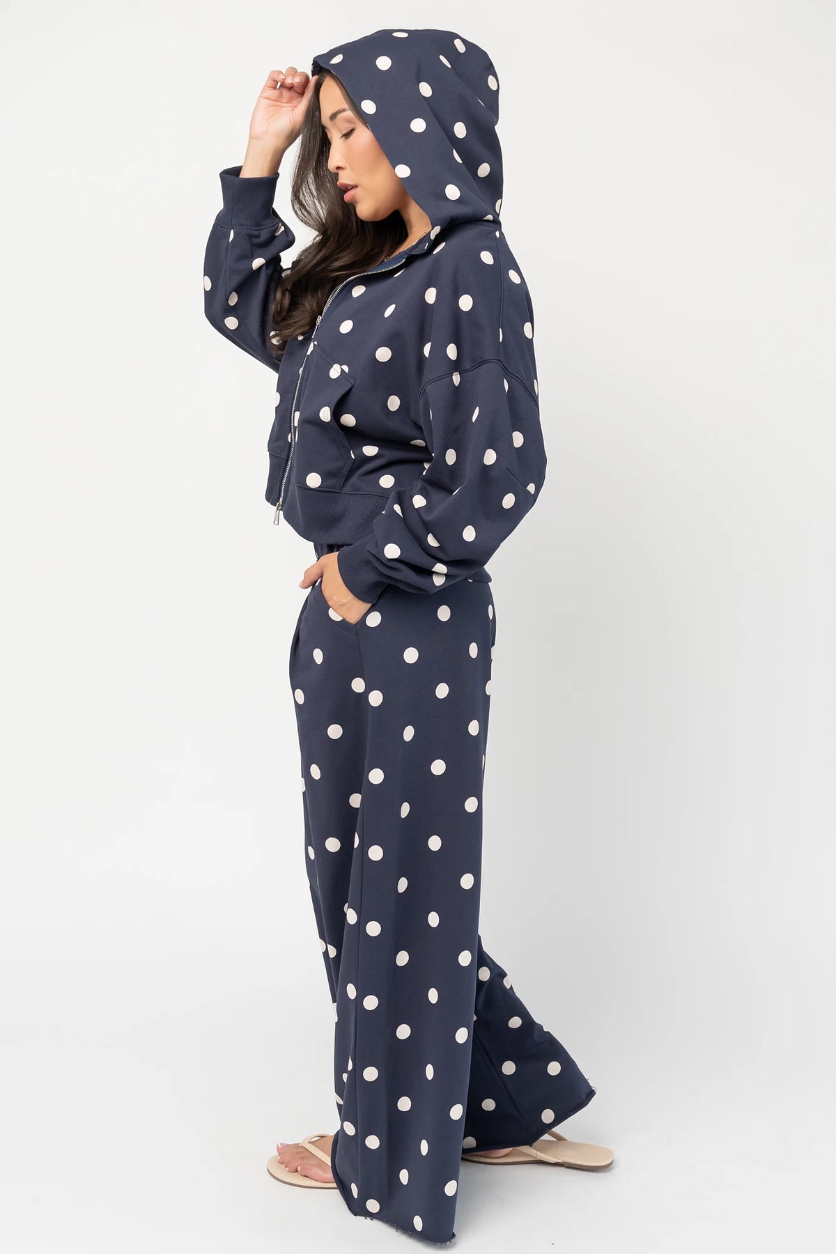 Lydia Zip Up Hoodie in Navy Dot with polka dot print, oversized fit, adjustable hood, zip front, and kangaroo pockets.