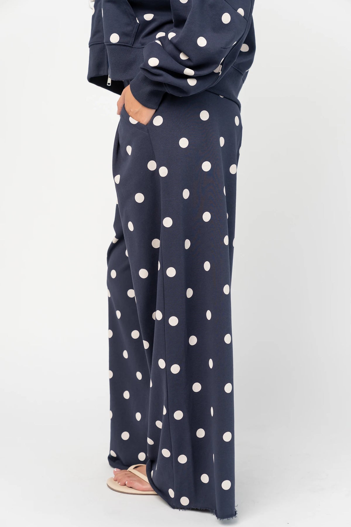 Lydia Wide Leg Sweatpants in Navy Dot with polka dot print, elastic waistband, side pockets, and raw hem.