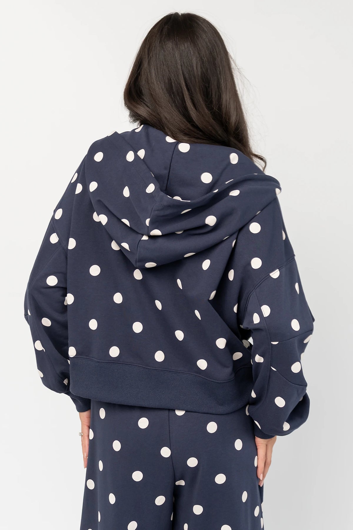 Lydia Zip Up Hoodie in Navy Dot with polka dot print, oversized fit, adjustable hood, zip front, and kangaroo pockets.