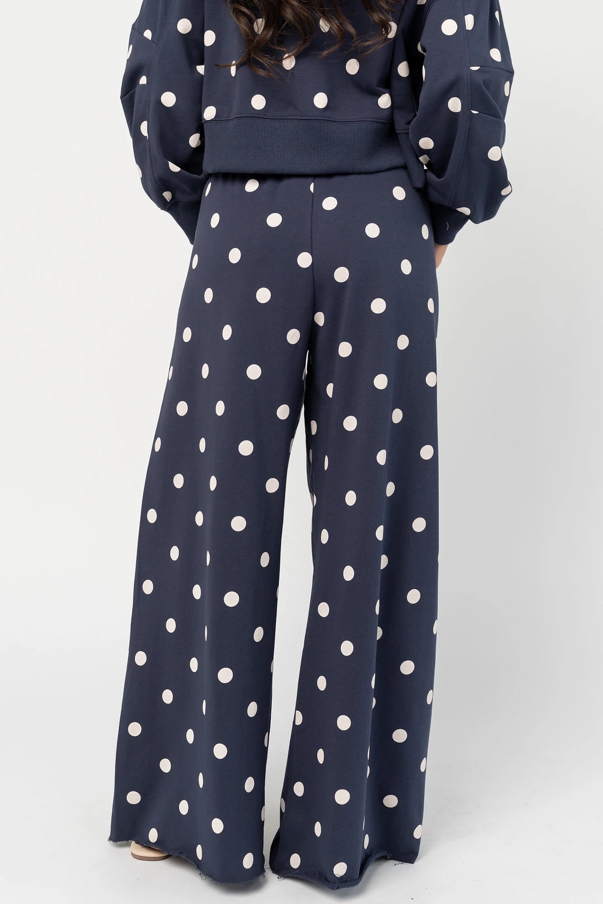 Lydia Wide Leg Sweatpants in Navy Dot with polka dot print, elastic waistband, side pockets, and raw hem.