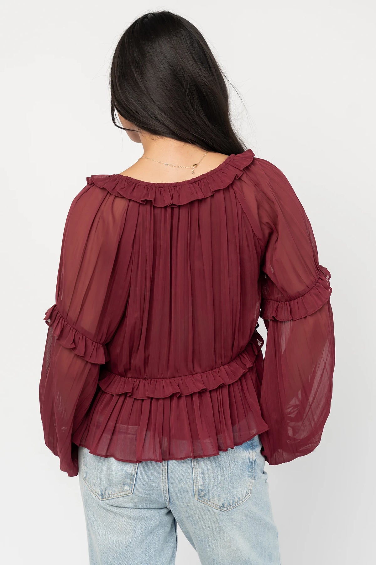 Bellerose Ruffle Top in Burgundy with pleated chiffon, ruffle-trimmed neckline, front tie, and billowy long sleeves.