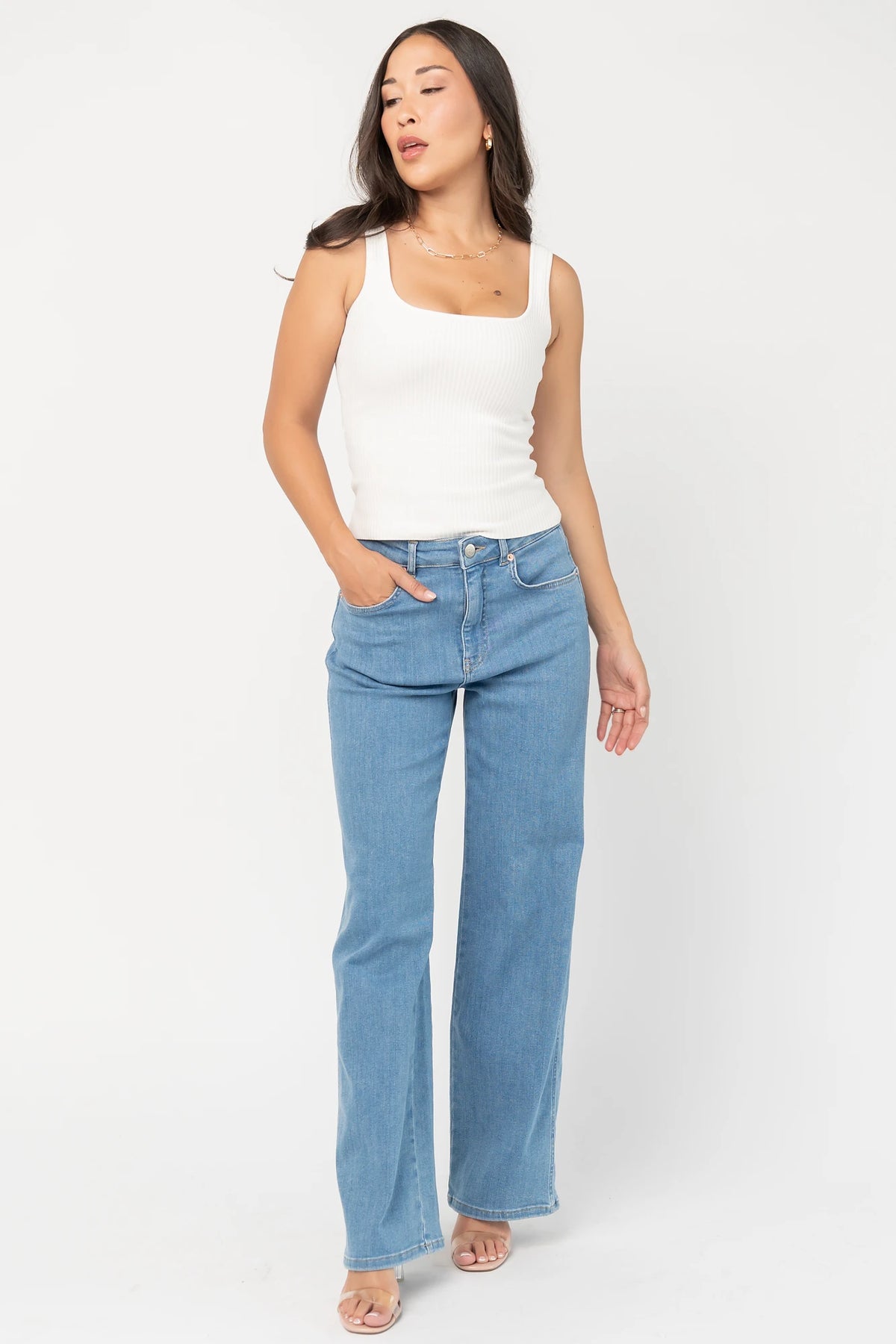 Vesper Mid Rise Wide Leg Jeans in Mid Wash with relaxed wide legs, mid-rise waist, button and zipper closure.