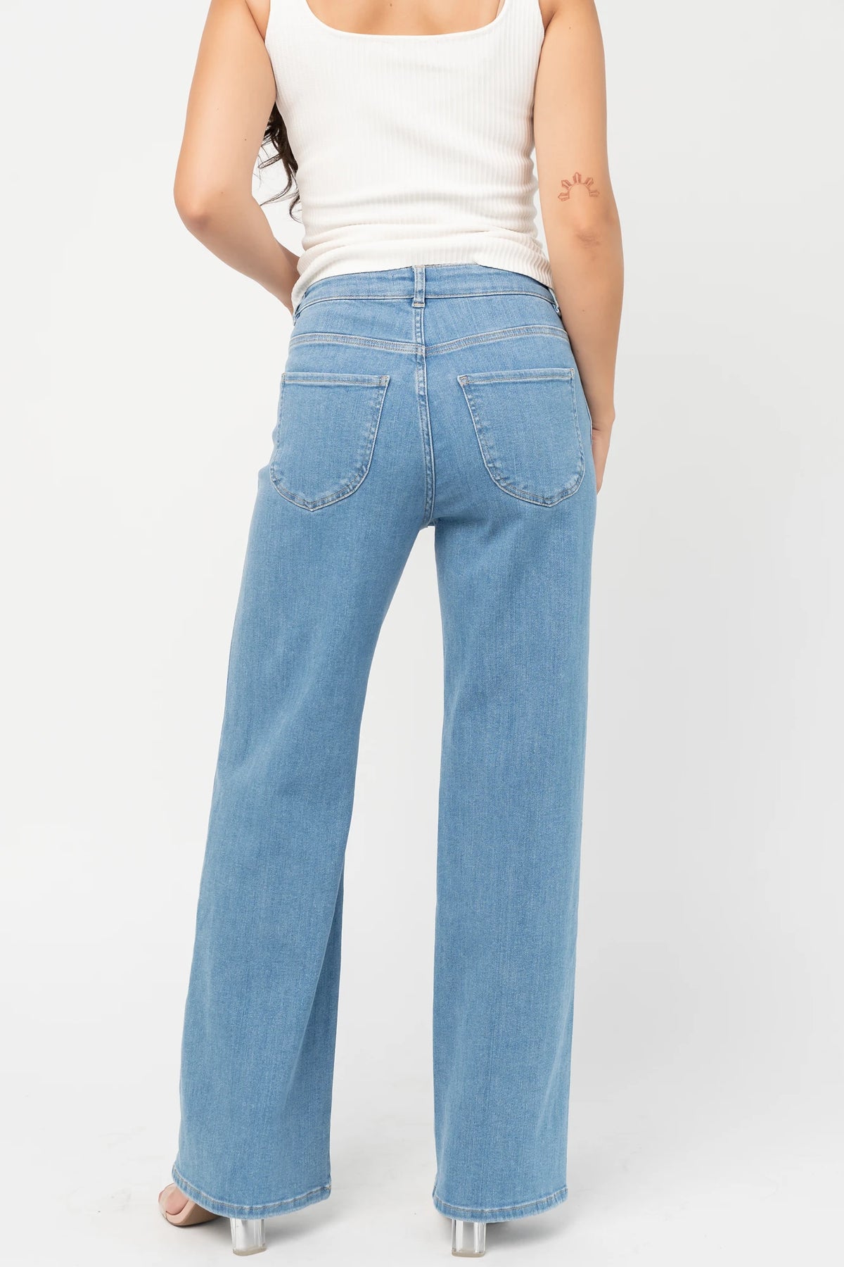 Vesper Mid Rise Wide Leg Jeans in Mid Wash with relaxed wide legs, mid-rise waist, button and zipper closure.