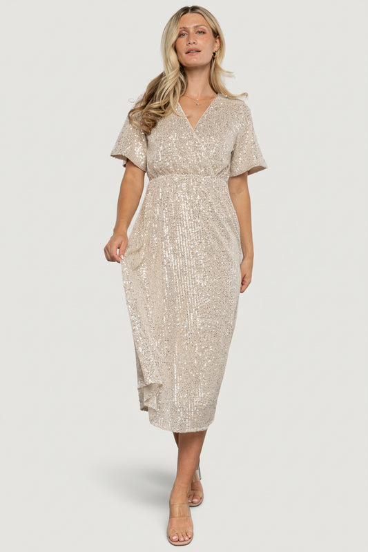 Model wearing Mayfair Sequin Midi Dress in champagne showing surplice neckline, short sleeves, and all-over silver sequins.