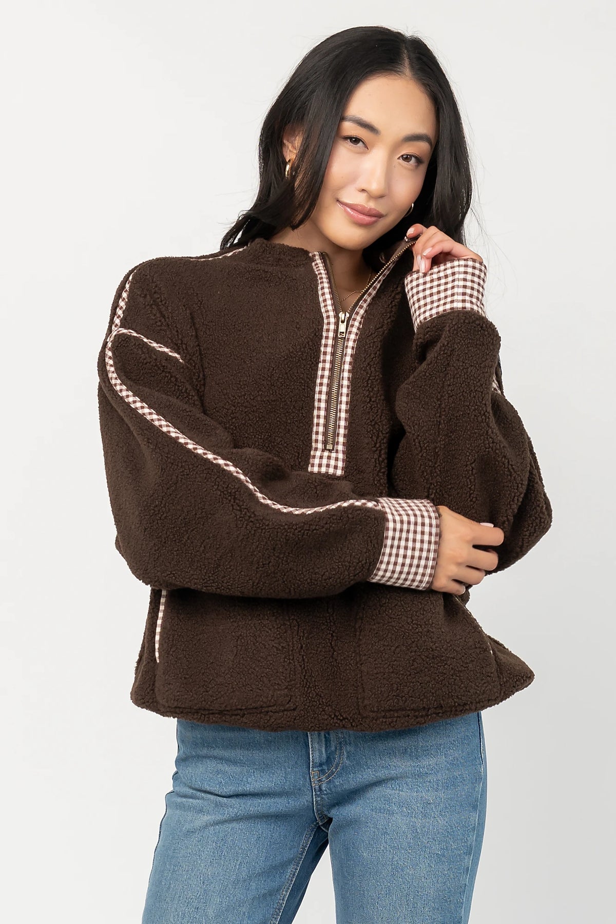 Tylee Fleece Jacket in Chocolate with sherpa fleece, half-zip neckline, brown gingham trim, fold-over cuffs, and side pockets.