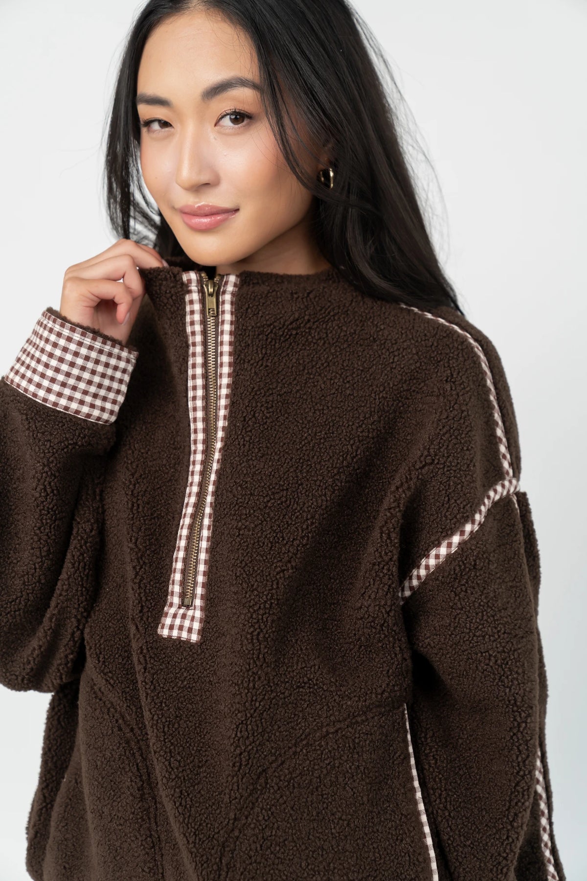 Tylee Fleece Jacket in Chocolate with sherpa fleece, half-zip neckline, brown gingham trim, fold-over cuffs, and side pockets.