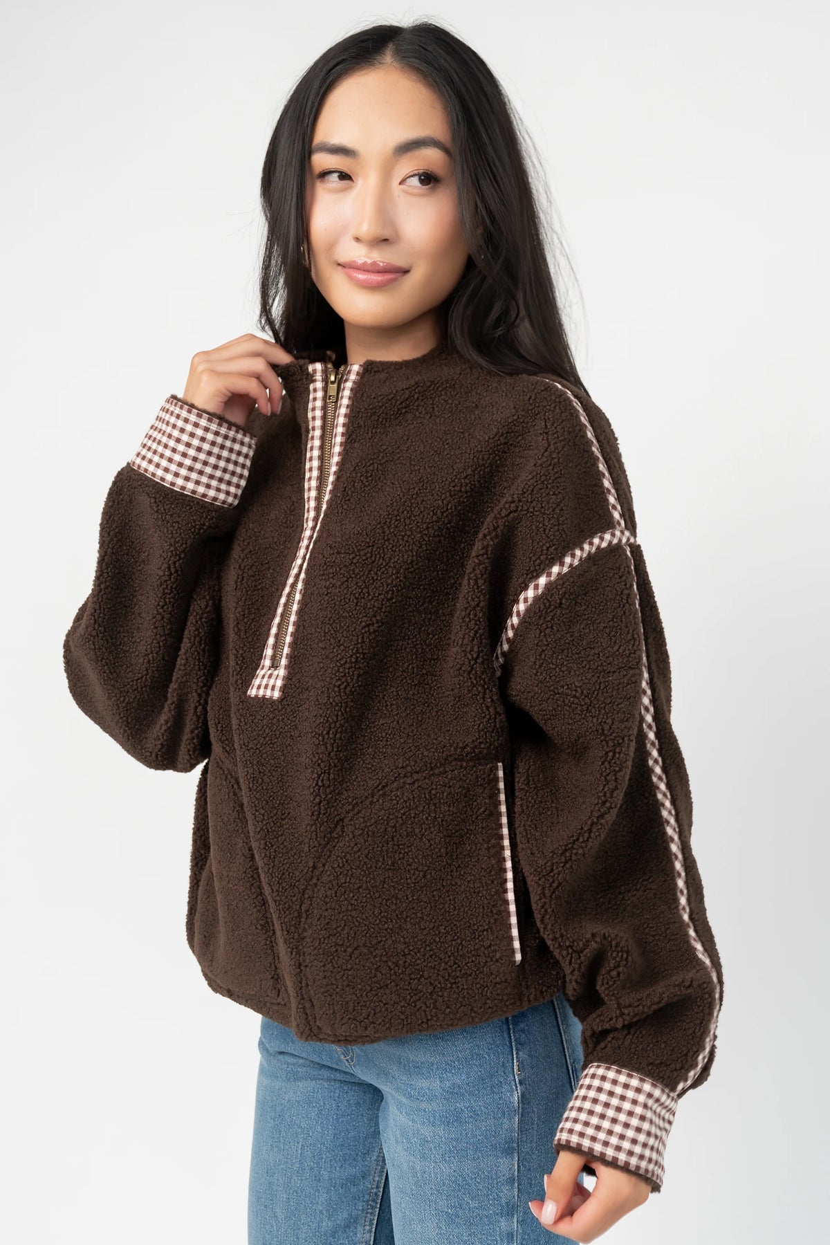 Tylee Fleece Jacket in Chocolate with sherpa fleece, half-zip neckline, brown gingham trim, fold-over cuffs, and side pockets.
